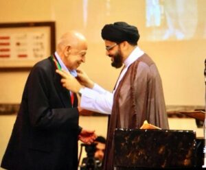 Maulana Sayeed Adeel Reza, Resident Alim of Dar es Salaam Jamaat, bestowing Husseini Medal on Alhaj Pyaralibhai Shivji in Dar es Salaam Imambargha